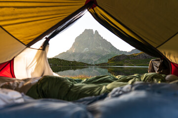 Mountain lake with reflections seen from a tent