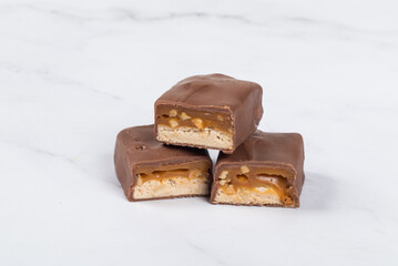 Candy bar with nougat, caramel, peanuts and hazelnuts. In chocolate. 