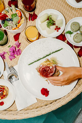 Luxurious floating breakfast served in a pool with a scenic mountain backdrop. Fresh fruits gourmet pastries and coffee create an indulgent morning experience in a serene outdoor setting in Greece