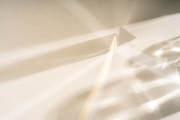 Abstract shadow sun glare from glass, empty background composition for product presentation. The background is beige. Showcase Nude Studio Minimal.