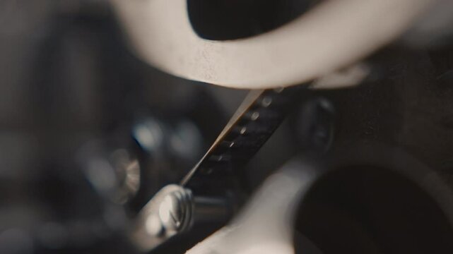 Close ups of a vintage 8MM projector spools moving and playing film 