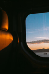 Moody roadtrip, car window with a view of sea at sunset