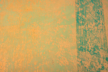 Green damaged plaster on concrete wall, old plaster needs repair. Abstract background, close-up, copy space