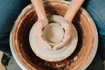Potter creates a ceramic bowl in the pottery studio. Process of making a unique ceramic shape.