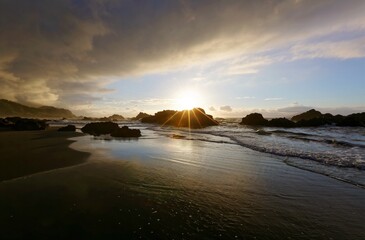 Golden rays of rising sun light up the sea waves at a beautiful rocky beach on Yilan Coast near Taipei, Taiwan ~ Fascinating sunrise scenery at Ilan seashore under dramatic dawning sky (Long Exposure)