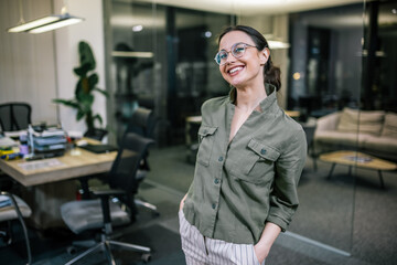 Young businesswoman posing confidently in a professional setting