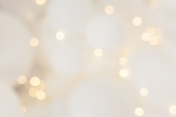 cream background with elegant gold bokeh particles