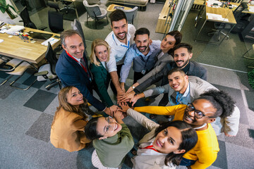 Stack of hands. Unity and teamwork in the office after an conference, seminar. Top view.