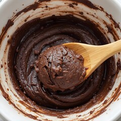 Thick fudge being stirred in a saucepan, with steam rising. Generative AI