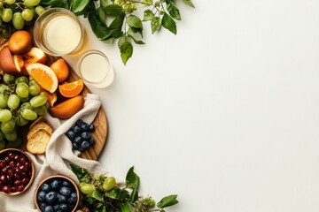 Fototapeta premium Colorful arrangement of fresh fruits and refreshing drinks on a light background inviting a healthy lifestyle