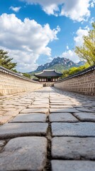 Stone path to temple, mountain backdrop, clear sky