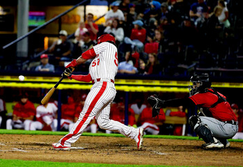 #57 baseball player bat on the ball