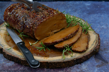 Roasted seitan rubbed with spices and bbq sauce on wooden board, sliced, copy space