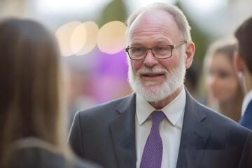 Experienced Leader: A distinguished senior executive with a white beard and glasses, exudes confidence and charisma, engaging in a conversation with a colleague in a professional setting.