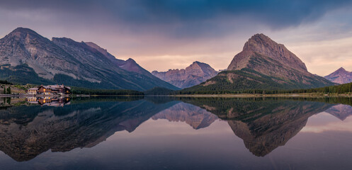 Panorama of  Swiftcurrent Lake with Many Glacier Hotel resort reflection at - Sunrise - Glacier...