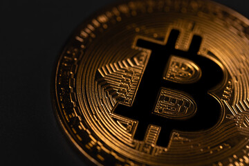 Bitcoin gold coin on the dark black background. P2P bitcoin trading. Peer-to-peer payment system. Digital cryptocurrency virtual money. Blockchain technology.