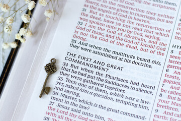 First and great commandment text in open holy bible book. Close-up. Christian love, faith, and obedience to God Jesus Christ.