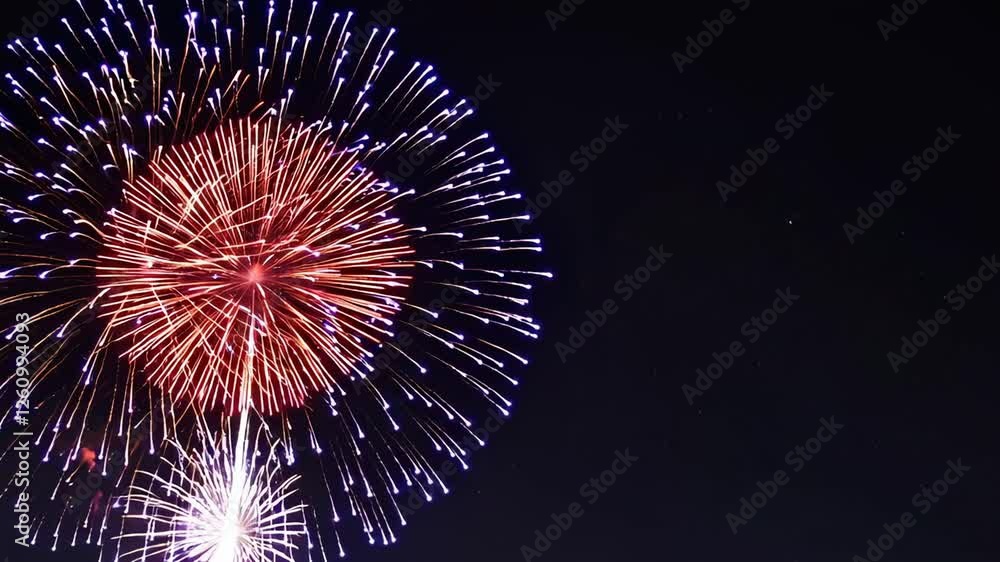 Poster Nighttime fireworks display exploding with vibrant colors, shimmering and sparkling in dramatic slow motion against dark sky backdrop