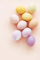 Natural dying Easter eggs on peach background. Easter greeting card.