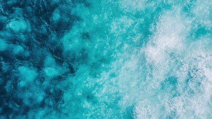 Aerial view of vibrant turquoise ocean water, showcasing waves and underwater textures, creating a serene and refreshing atmosphere.