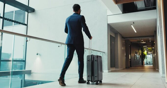 Businessman, walking and suitcase with phone for travel, immigration or work trip at office building. Male person, employee or immigrant with luggage for job opportunity or new career at workplace