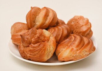 A custard pie. Eclair with cream. Delicious profiteroles.