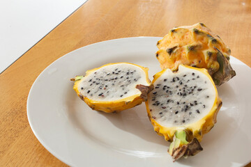 A view of a sliced half of a yellow dragon fruit.