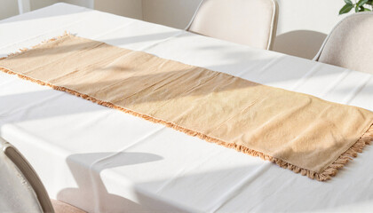 Stylish burlap table runner on elegant dining table with natural light