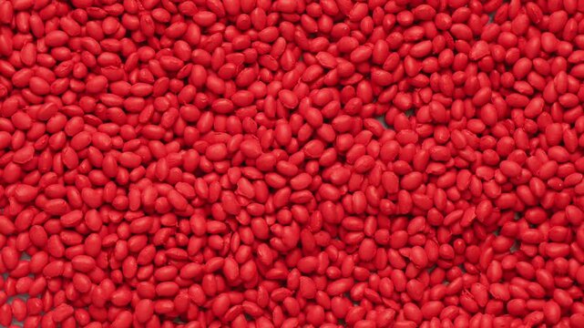 Red polymer dye in granules, background texture