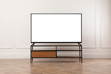Tv set with white screen on stand in room. Mockup for design