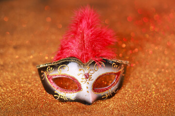 Beautiful carnival mask on shiny color background, closeup