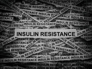 Strips of newspaper with the words Insulin Resistance typed on them. Black and white.