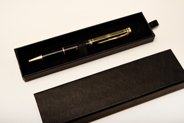 A gift pen in a box. A black fountain pen.