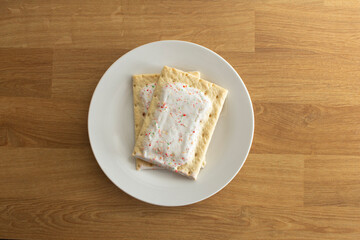 A top down view of some popular strawberry toaster strudels on a plate.