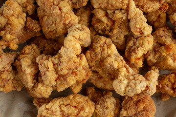 A top down view of a pile of Korean fried boneless chicken, as a background.