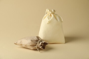 Two color burlap sacks on beige background