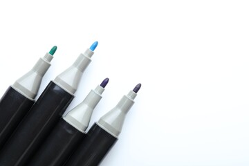 Many colorful markers on white background, top view