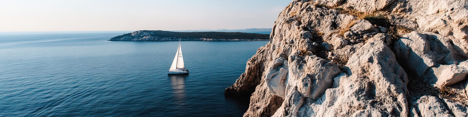 Fototapeta premium Sailboat, Sea, and Coastal Cliff