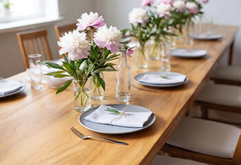 Fototapeta premium Blossoming Romance: A long rustic table surrounded by mismatched wooden chairs, draped in pale blush linen. The table features lavender sprigs tied with twine on each plate, small tea light candles, a
