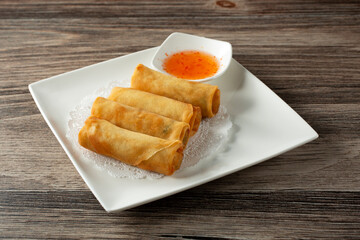 A view of a plate of egg rolls.