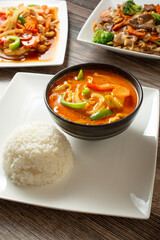 A view of a yellow curry entree, among other entrees.