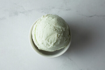 A top down view of a bowl of pandan ice cream.