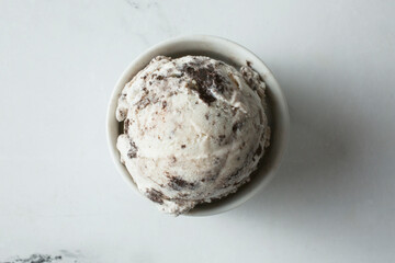 A top down view of a bowl of cookies and cream ice cream.