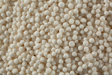 A top down view of a pile dry tapioca pearls, as a background. 
