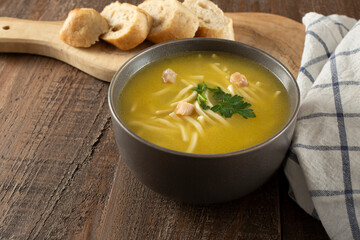 A view of a bowl of chicken noodle soup.