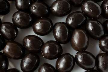 A top down view of a layer of black olives, as a background.