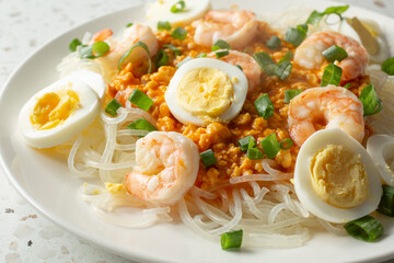 A closeup view of a plate of pancit palabok.