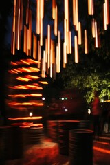 Nighttime light streaks illuminate barrels.