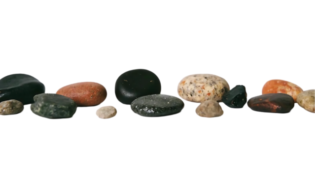 A collection of smooth gray rocks are scattered on transparent background