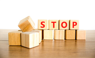 Stop symbol. Concept word Stop on beautiful wooden blocks. Beautiful wooden table white background....